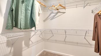 Clothes hanging on a rack in a room at The Mark Townhomes Apartments, Harrisonburg, VA